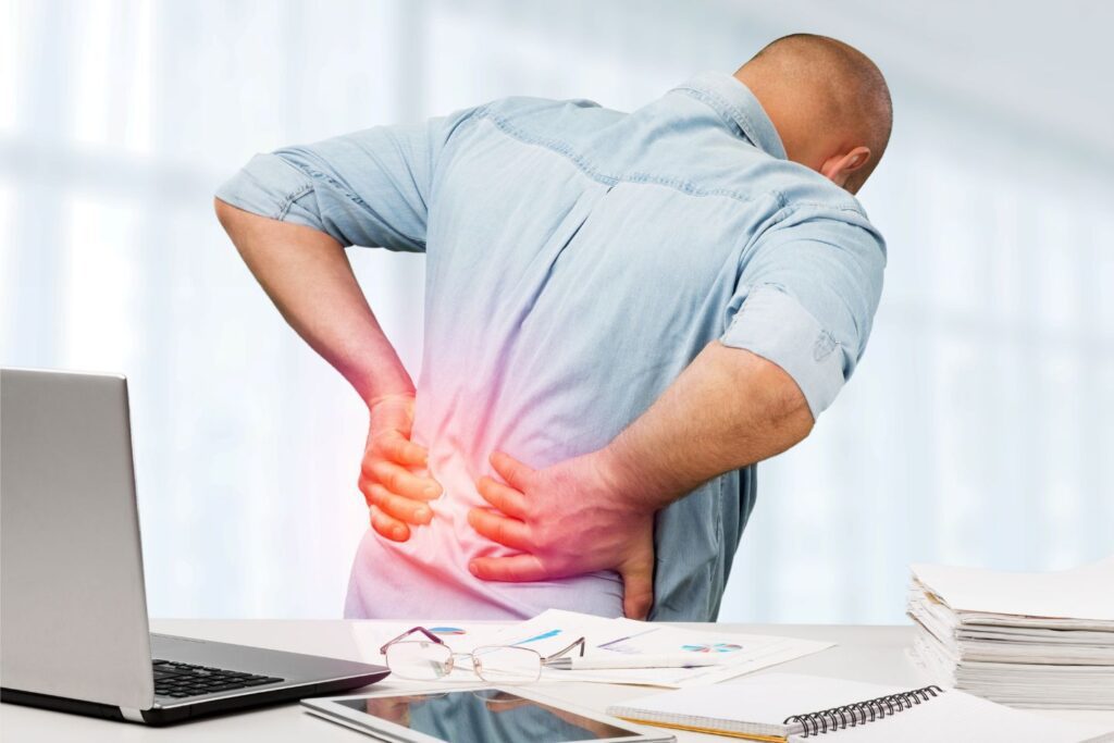 Man in pain, holding his lower back